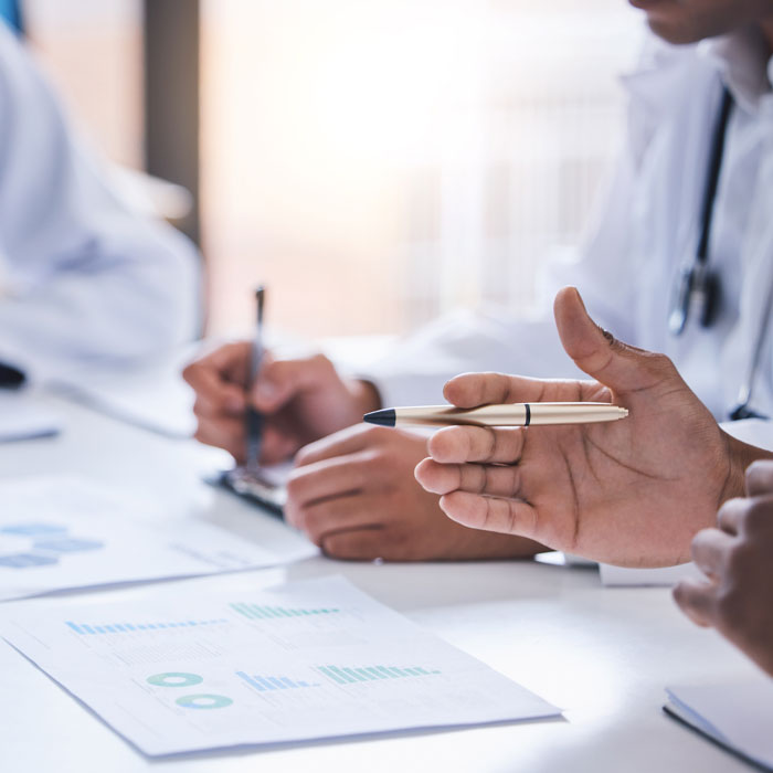 doctors sitting around a table of paperwork