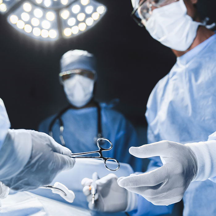 surgeon being handed an instrument